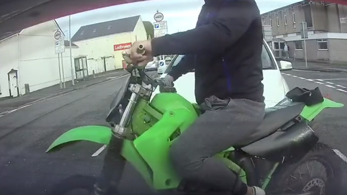 Unskilled motorcyclist comically fails wheelie attempt on British road